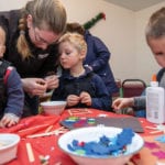 Sarah Moore of MacGregor and her children Zane, Callen and Walker make a Christmas craft.