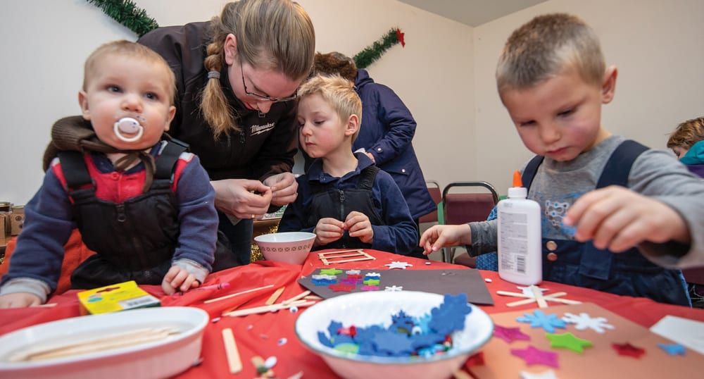 Sarah Moore of MacGregor and her children Zane, Callen and Walker make a Christmas craft.