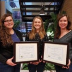From left, holding the awards: Laura Schmidt, MPSG extension co-ordinator, Cassandra Tkachuk, MPSG production specialist and applied soybean and pulse research agronomist Kristen MacMillan.