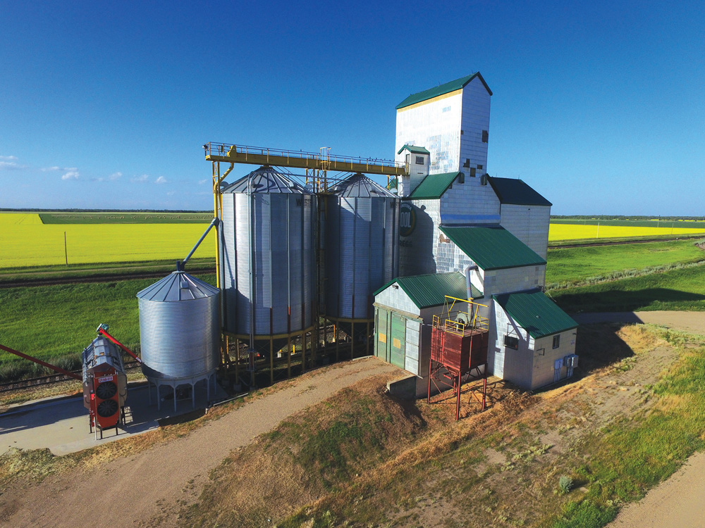 An elevator at Gregg, on the CNR line northeast of Carberry, was built in 1931 by the Scottish Co-operative Wholesale Society. A crib annex on its east side dates from 1955 and two steel tanks were added in 1991. Sold in 1973 to Manitoba Pool, its closure in October 2000 coincided with the merger of Agricore and UGG, although the Pool logo remained on its west side when this photo was taken in July 2017. It continues to be used for private grain storage.