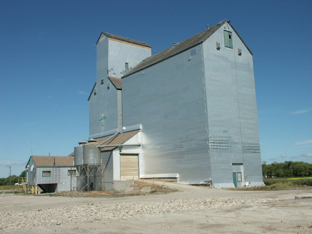 An elevator at Dunrea was built in 1928 by Manitoba Pool Elevators. In 1968, its 70,000-bushel capacity was expanded by a 110,000-bushel crib annex. Renovated in 1983 and 1987, the facility was closed by Agricore in mid-2001 and sold into private hands. In mid-March 2006, a blaze in the facility was fought by firefighters from Dunrea, Ninette, and Killarney. The wood burned down to the level of grain in the bins, some of which was later salvaged, and the remainder was demolished. 