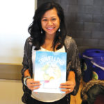 Kaycelyn Rosales-Knight with her children’s book.