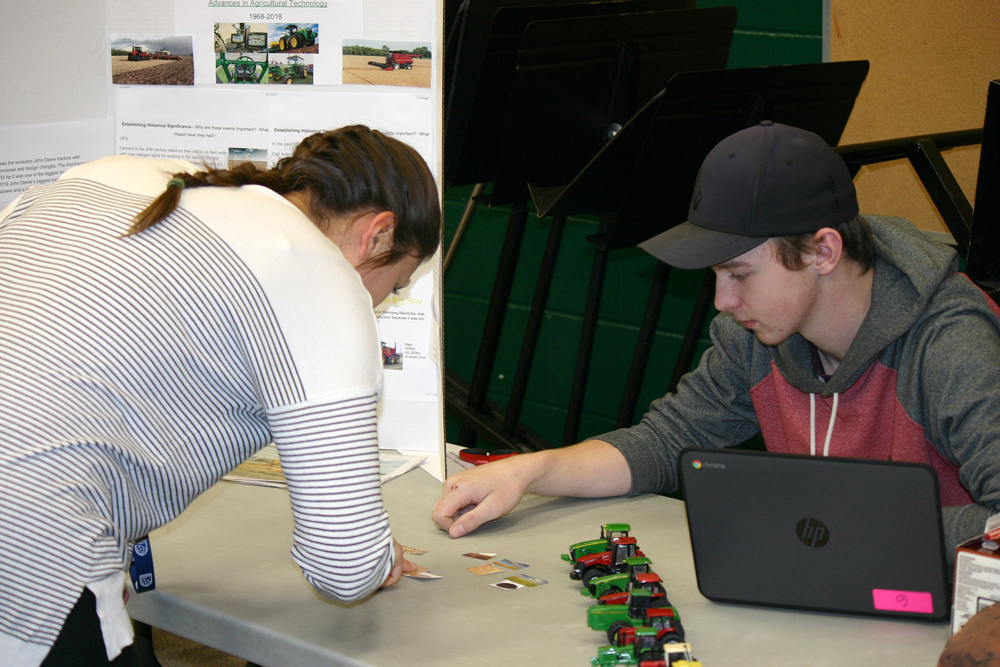 Teacher Chelsey Kostesky was asked to sort grain product pieces as part of Keegan Gamey’s project on Advancement in Ag Technology.
