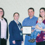 Cameron and Lisa Hodgins (on the right side) accept this year’s Manitoba TESA award from the Manitoba Beef Producers, presented by Pam Miller of sponsor Myers Norris Penny (far left) and Jade Delaurier of Manitoba Beef Producers.