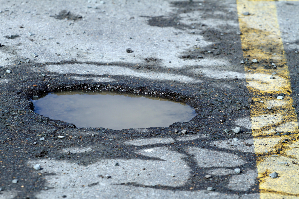 Pot Hole On City Street, A Hazard To Motorists