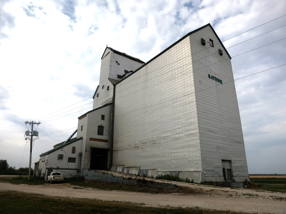 A 72,000-bushel elevator at Katrime, on the CNR line 22 miles northwest of Portage la Prairie, was built by Manitoba Pool in 1953 to replace a smaller elevator. A crib annex was built beside it in 1969, increasing total capacity to 174,000 bushels. Extensive renovations between March and August 1986 included installation of an electronic scale, a larger driveshed and office, and replacement of wooden legs by steel ones. The facility was closed by Agricore in 2001 and the siding tracks were removed. It continues in use for private grain storage.