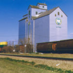 Altona Pool: This elevator at Altona was built in 1951 by Lake of the Woods Milling Company. Purchased by Manitoba Pool in 1959, it was the Pool B elevator until early 1965 when Pool’s A elevator was moved to Plum Coulee. Crib annexes were built on each side of it in 1967 and 1969, and the elevator was fully renovated in 1970. Closed by Agricore in 2001, the elevator was demolished.