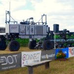 The U-shaped Dot A-U1 “loads” a SeedMaster row-crop planter on to its platform during the demonstration at Canada’s Outdoor Farm Show. (Ralph Pearce photo)

