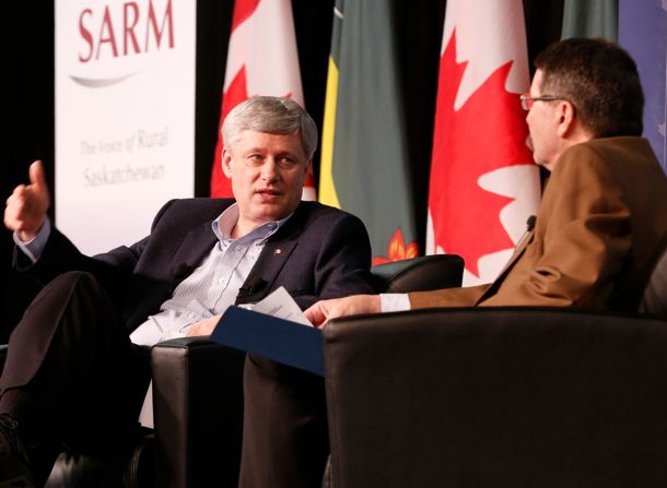 Prime Minister Stephen Harper, shown here with Saskatchewan Association of Rural Municipalities (SARM) president Ray Orb in Saskatoon on Thursday, said Canada’s big two railways can’t be allowed to define “satisfactory” in terms of grain handling service. (PMO photo by Jill Thompson)
