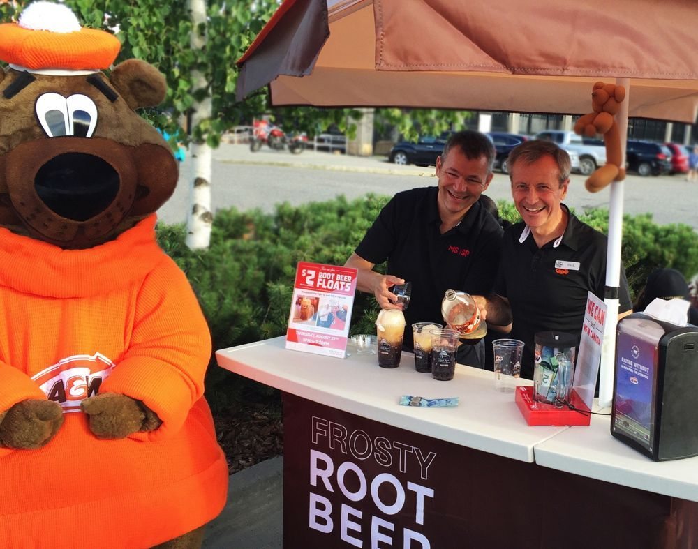 A+W CEO Paul Hollands, shown here at right during the chain’s Cruisin’ to End MS promotion in August, said the chain’s “better ingredients” campaign is still having a “powerful impact” on consumers. (CNW Group/A+W Food Services of Canada)
