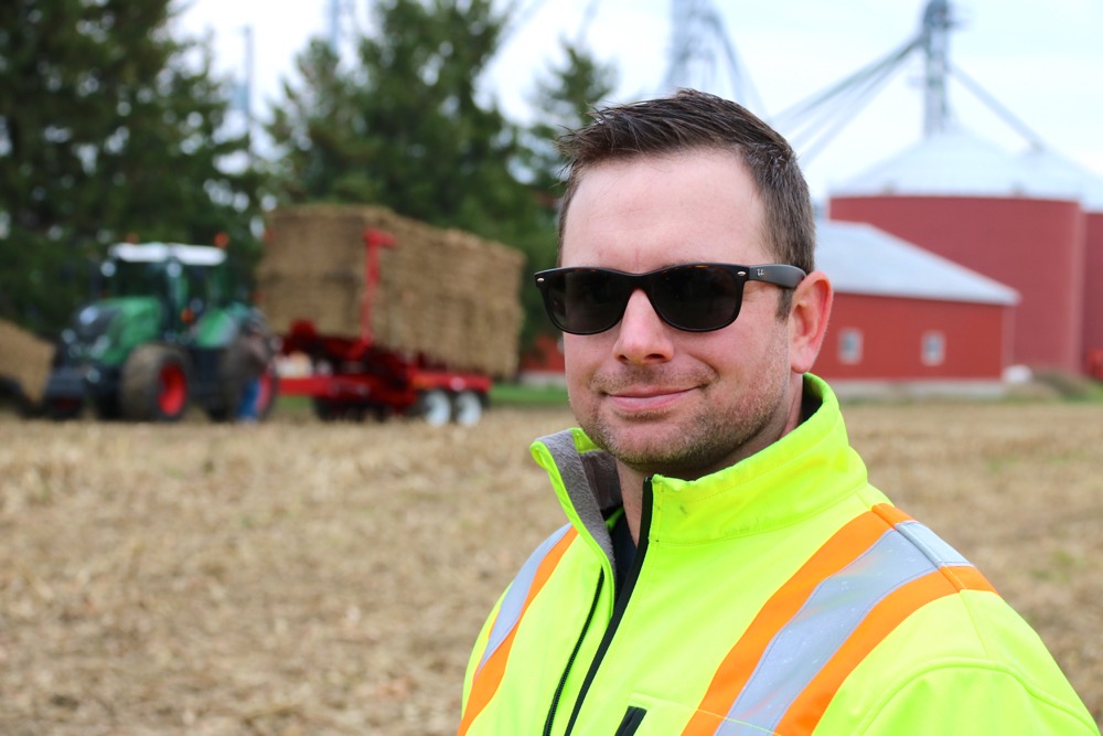 Dave Park, Sarnia-area farmer and president of the Cellulosic Sugar Producers Co-operative stands in front of one of the bale accumulators that will be used by the co-op.  Photo: John Greig
