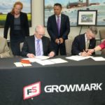 Representatives from Growmark and Cofco have signed on for a new grain supply agreement. (Photo courtesy Growmark)
