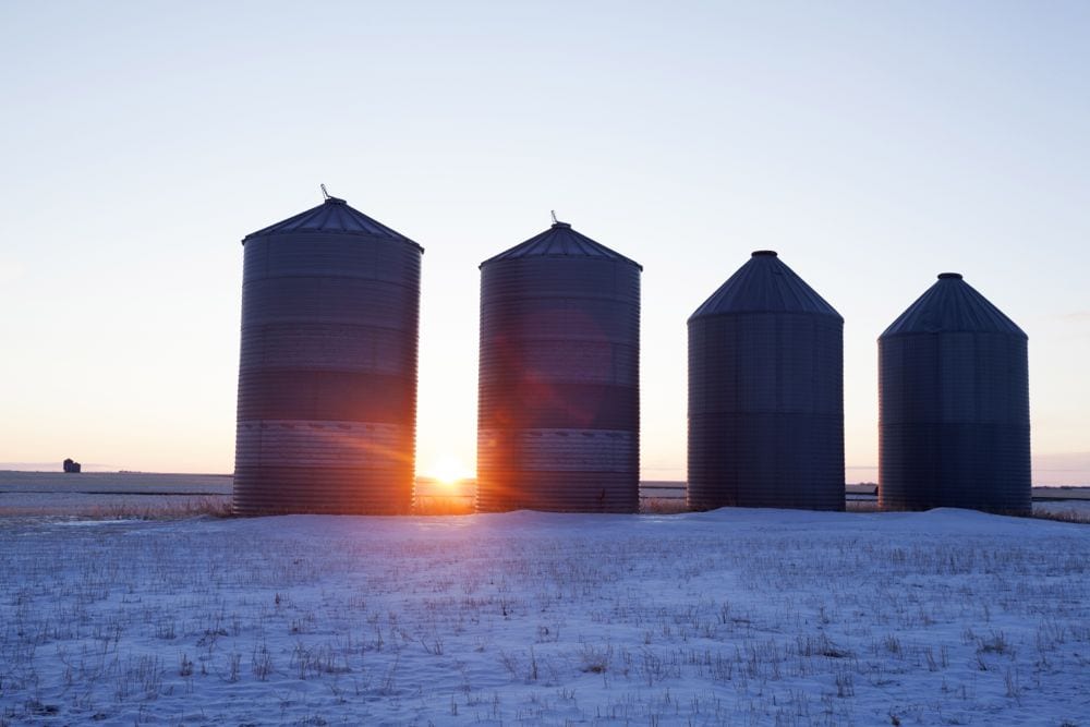Grain bins in a Saskatchewan field. (MysticEnergy/iStock/Getty Images)
