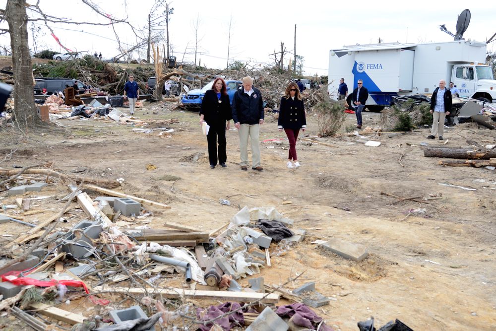 U.S. President Donald Trump and First Lady Melania Trump survey damage and are briefed by a FEMA official on March 8, 2019 in Beauregard, Alabama, where 23 people in Lee County were killed by tornadoes earlier in the week. (Photo: Reuters/Mike Theiler)
