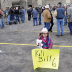 A three-year-old holds a protest sign ahead of a Dec. 2, 2015 meeting at Okotoks, Alta. between farmers and ranchers and Alberta’s then-ministers of labour and agriculture. (Photo: Reuters/Mike Sturk)