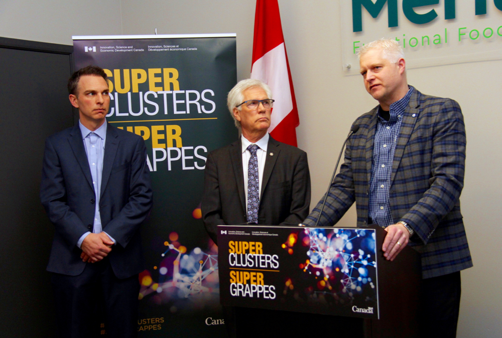 Bill Grueul, CEO of Protein Industries Canada, addresses reporters January 10 as Jim Carr, Prime Minister Trudeau’s special representative for the prairies, and Merit Functional Foods co-CEO Ryan Bracken look on.