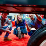 Rhett Dodds and Siobhan Jackson get the rundown on the MacDon Flexdraper FD135 header from Andrew Gossart of Winnipeg.