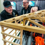 Gerald Boyd of Minnedosa gets the details on a post frame building from Ron Cook, of the Steinbach McMunn and Yates.