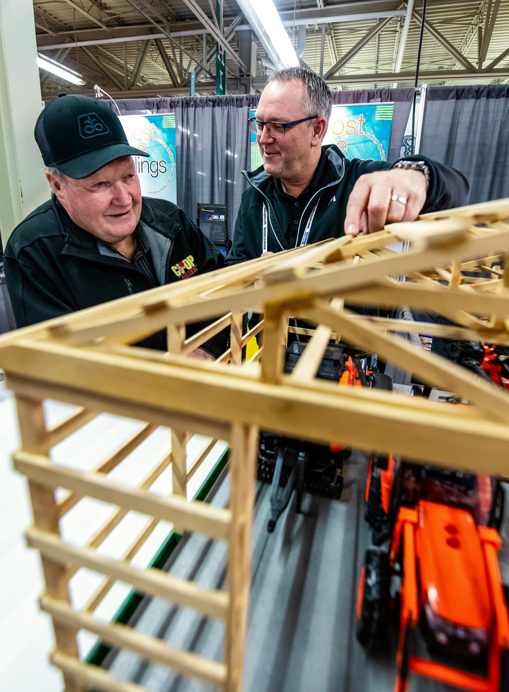 Gerald Boyd of Minnedosa gets the details on a post frame building from Ron Cook, of the Steinbach McMunn and Yates.