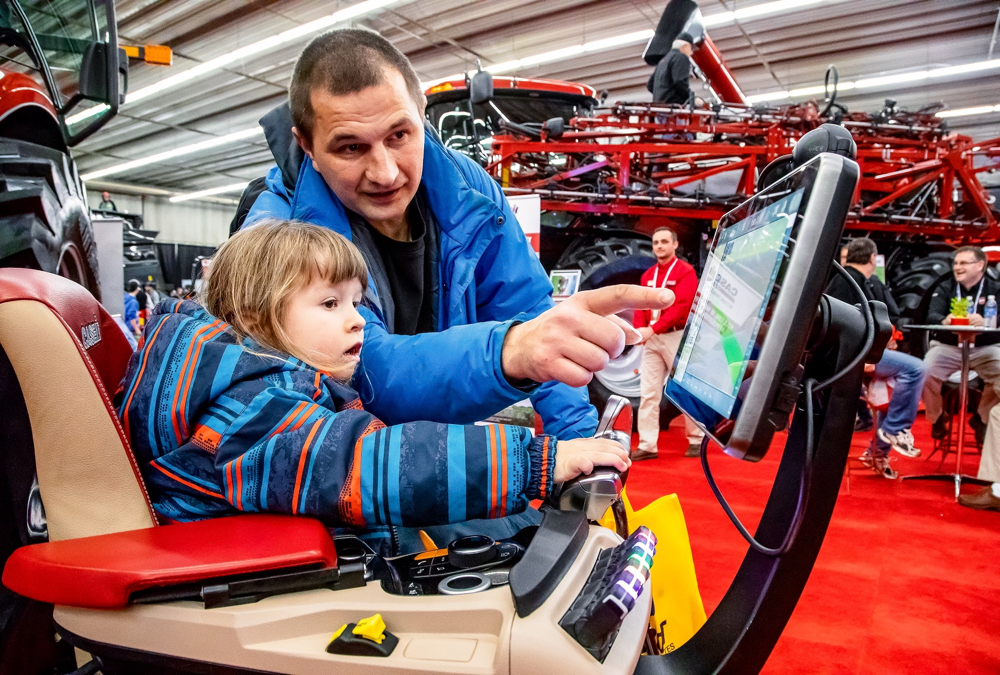 Andriy Kovalemko of Brandon helps his 3 1/2 year old son, also Andriy, navigate a driver operating system simulator.