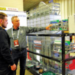 Maurice Melnyk (right) of Penner Farm Services fields grain dryer questions from a potential customer during Ag Days 2020.