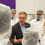 Blaine Pedersen, minister of agriculture and resource development, with ACC students at the grand opening of a new animal protein-processing training facility.