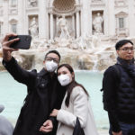 Tourists take a selfie in front of Rome’s Trevi Fountain on Jan. 31 after two cases of novel coronavirus 2019-nCoV were confirmed in Italy.