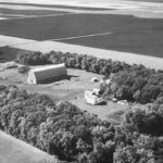 This old black and white aerial photo shows our farmyard four generations ago. My husband’s great-grandparents settled here in 1926, a second move after immigrating from Scotland in 1922. They wanted a farm with trees, good drinking water and soil without stones. This site fits the criteria to make living and farming here better. Much has changed since but reminders of our past remain with some of the buildings repurposed or repaired. Old steel wheels and pieces of harrow bar grace my flowerbeds and garden. Picture frames have been made from discarded barn windows. Our kitchen table and chairs are crafted from wooden barn beams. It’s important to remember our history and to look back with gratitude on the hard work, determination and resilience of our ancestors. It ensured we could farm, make a life and a living here.