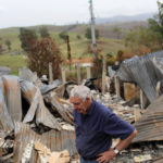 Farmer Jeff McCole, 70, pauses in front of his family home destroyed by bushfire in Buchan, Victoria, Australia, Jan. 23, 2020.