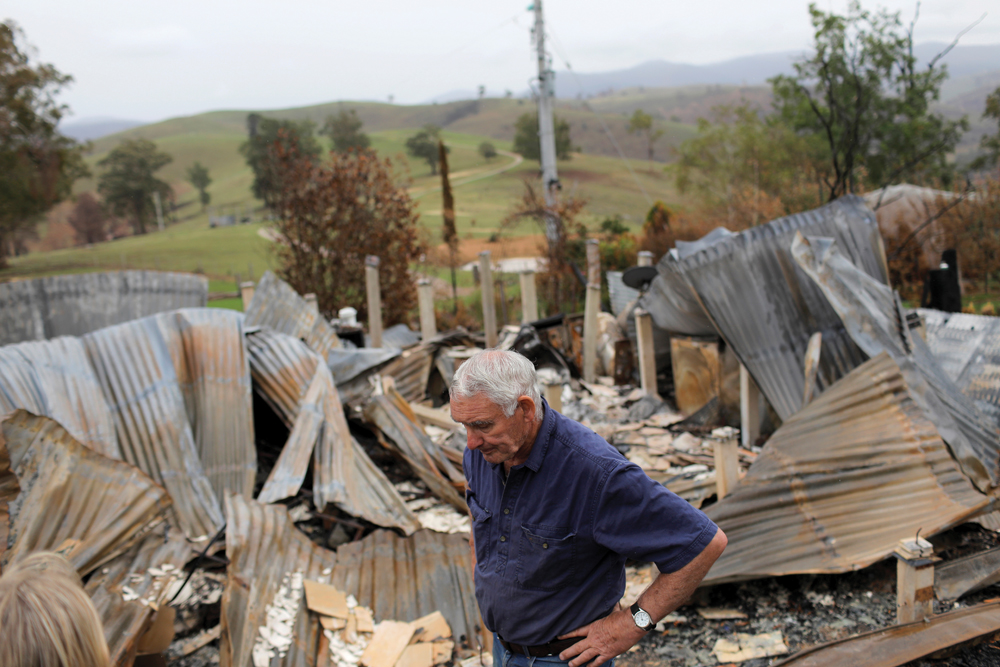 Farmer Jeff McCole, 70, pauses in front of his family home destroyed by bushfire in Buchan, Victoria, Australia, Jan. 23, 2020.