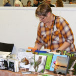 Deb Maluk showcases photo tiles among craft mart exhibitors.