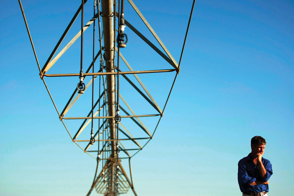 Farmer Ian Shippen stands under a mobile irrigation boom stretching nearly half a kilometre on his farm in the heart of Australia’s Murray-Darling River basin.
