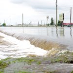 Floodwaters claim the main road access to the Brandon Municipal Airport on June 29, 2020.