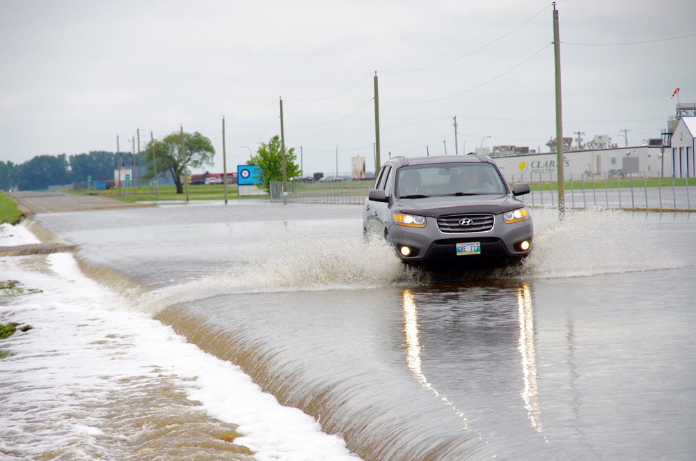 Floodwaters claim the main road access to the Brandon Municipal Airport June 29.