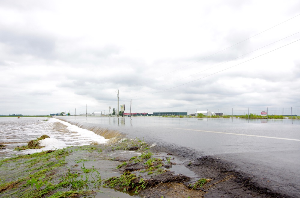 Floodwaters claim the main road access to the Brandon Municipal Airport June 29.