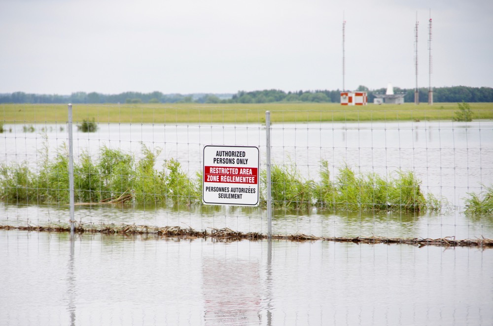 Floodwaters claim the main road access to the Brandon Municipal Airport June 29.