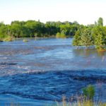 Neepawa's green space north of Highway 16 fills with flood water July 1 after one out of a string of storms to cause flooding across western Manitoba.