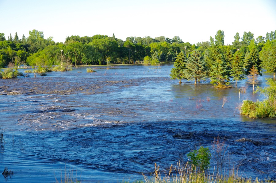 Neepawa's green space north of Highway 16 fills with flood water July 1 after one out of a string of storms to cause flooding across western Manitoba.