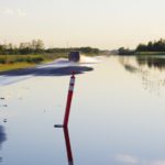 Flood waters overrun Highway 24 west of Rapid City.