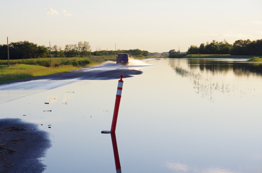Flood waters overrun Highway 24 west of Rapid City.