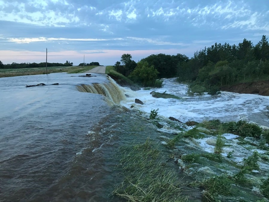 A municipal road north of Brandon goes from dry to dramatic waterfall in the space of three hours June 29.