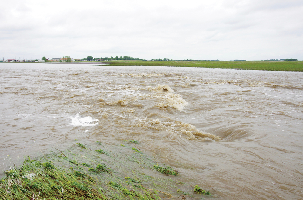 Fast running waters replace what was an approach just north of Brandon following intense thunderstorms that brought torrential rains.