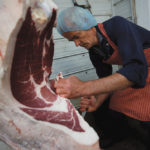 Mobile butcher Gerrit vande Bruinhorst works on a beef carcass.