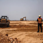 Workers and excavators are seen at a construction site of a new pig farm in Beijing’s eastern Pinggu district.