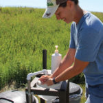Angie Cormier demonstrates how to use the wash station that her dad designed
and fabricated for their farm.