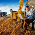 A farmer at his computer.