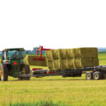 A producer in west-central Manitoba moves bales earlier this year.