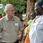 Jim Cornelius visits with Victoria Loki and her baby, Cecilia, in South Sudan in 2015.