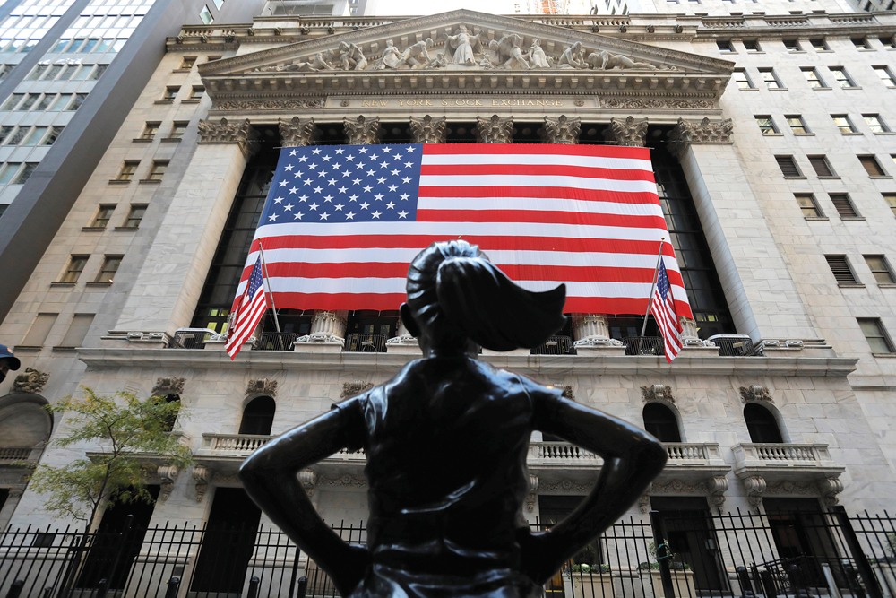 The Fearless Girl statue is seen outside the New York Stock Exchange (NYSE) on election day in Manhattan, New York City.