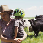 Michelle Schram, with her young son, on the farm she co-runs with husband Troy Stozek near Cartwright.